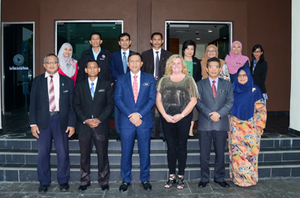 Cathy Hockaday poses with Malaysian drug prevention officials